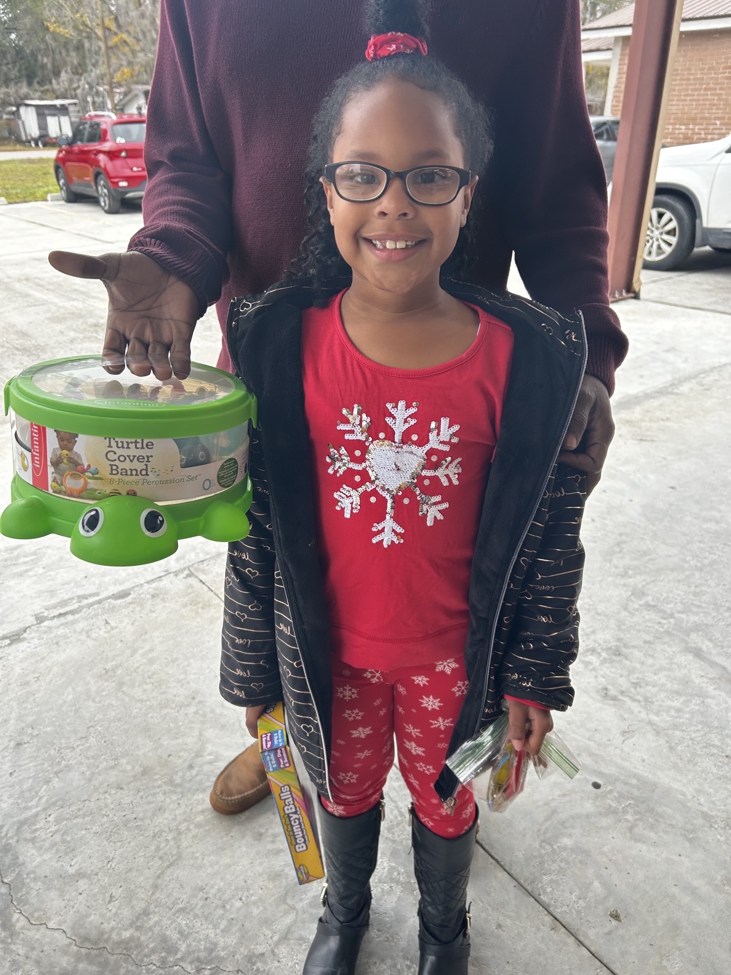 child posing with presents from toy drive